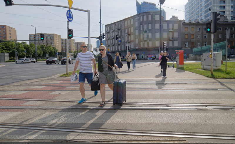 People crossing a busy street in Warsaw, Poland